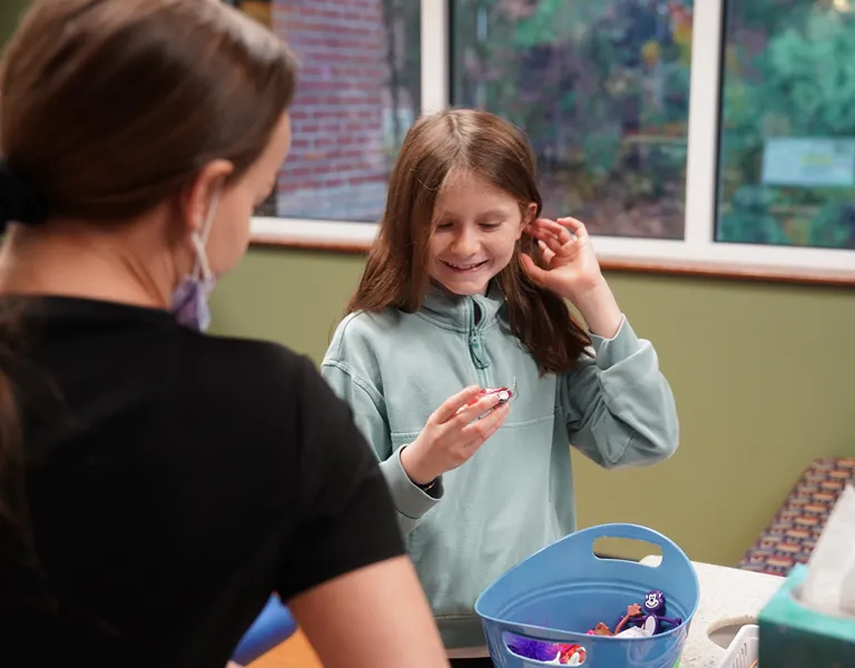 Girl picking out prize in basket