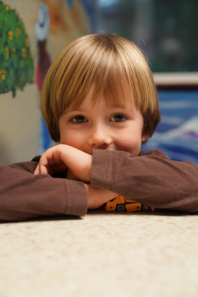 Kid with head on top of arms